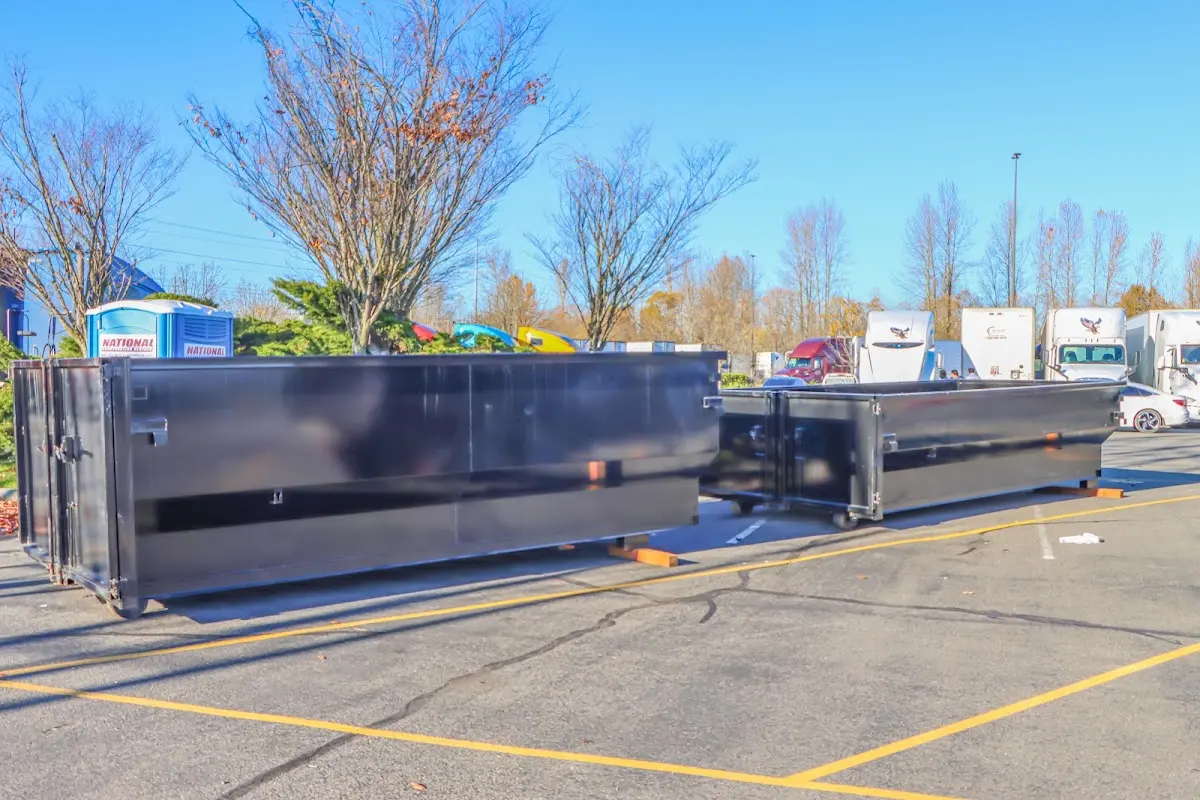Professional dumpster rental service with roll-off container on residential driveway in Fairview Park